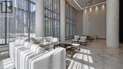 A modern living room with white furniture and large windows.