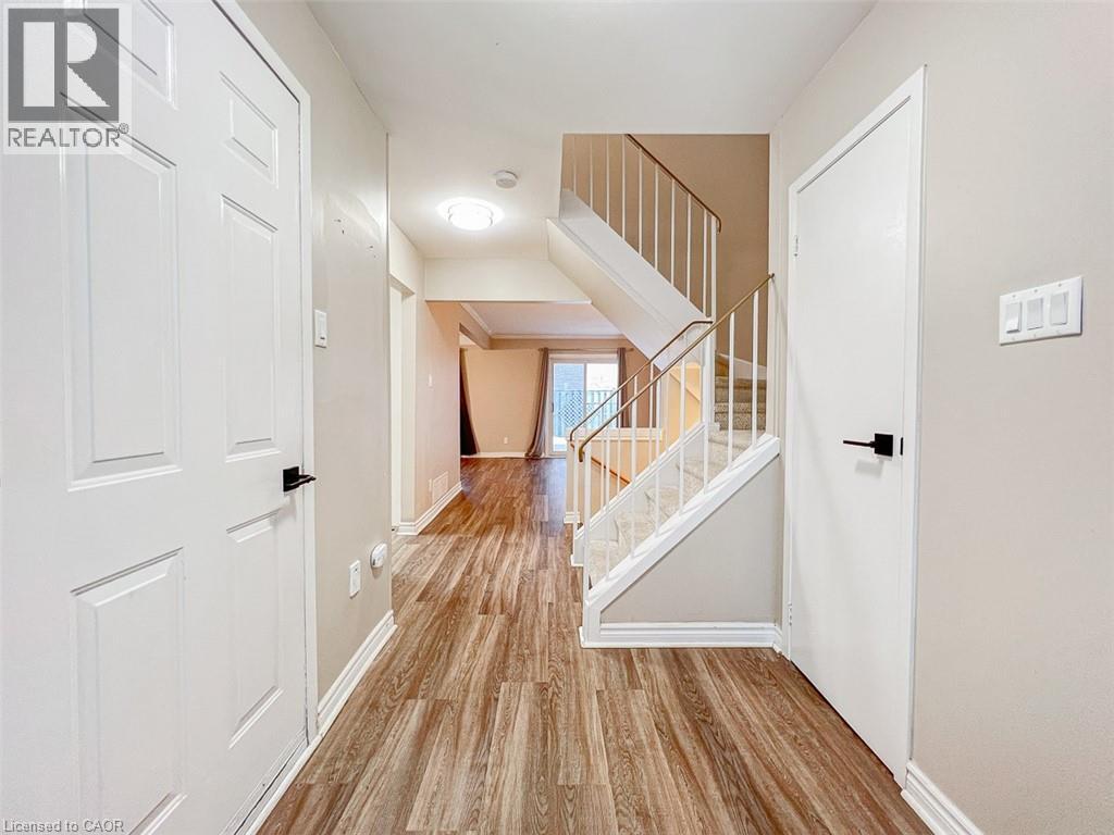 A hallway with a staircase and white doors.