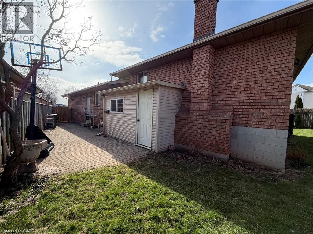 A red brick house with a white garage door and a basketball hoop.