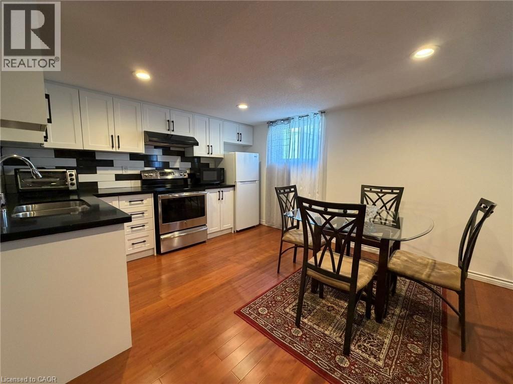 A kitchen with a table and chairs in the middle of the room.