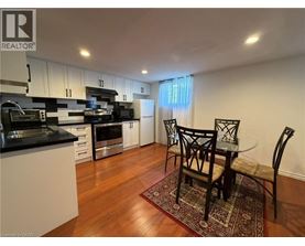 A kitchen with a table and chairs in the middle of the room.