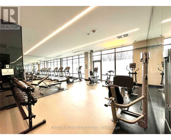 A gym with a variety of equipment including treadmills, weights, and exercise machines.