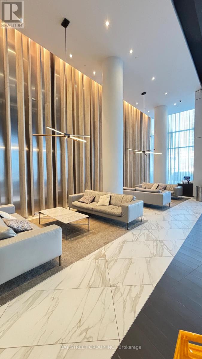 A living room with a white couch and a marble floor.