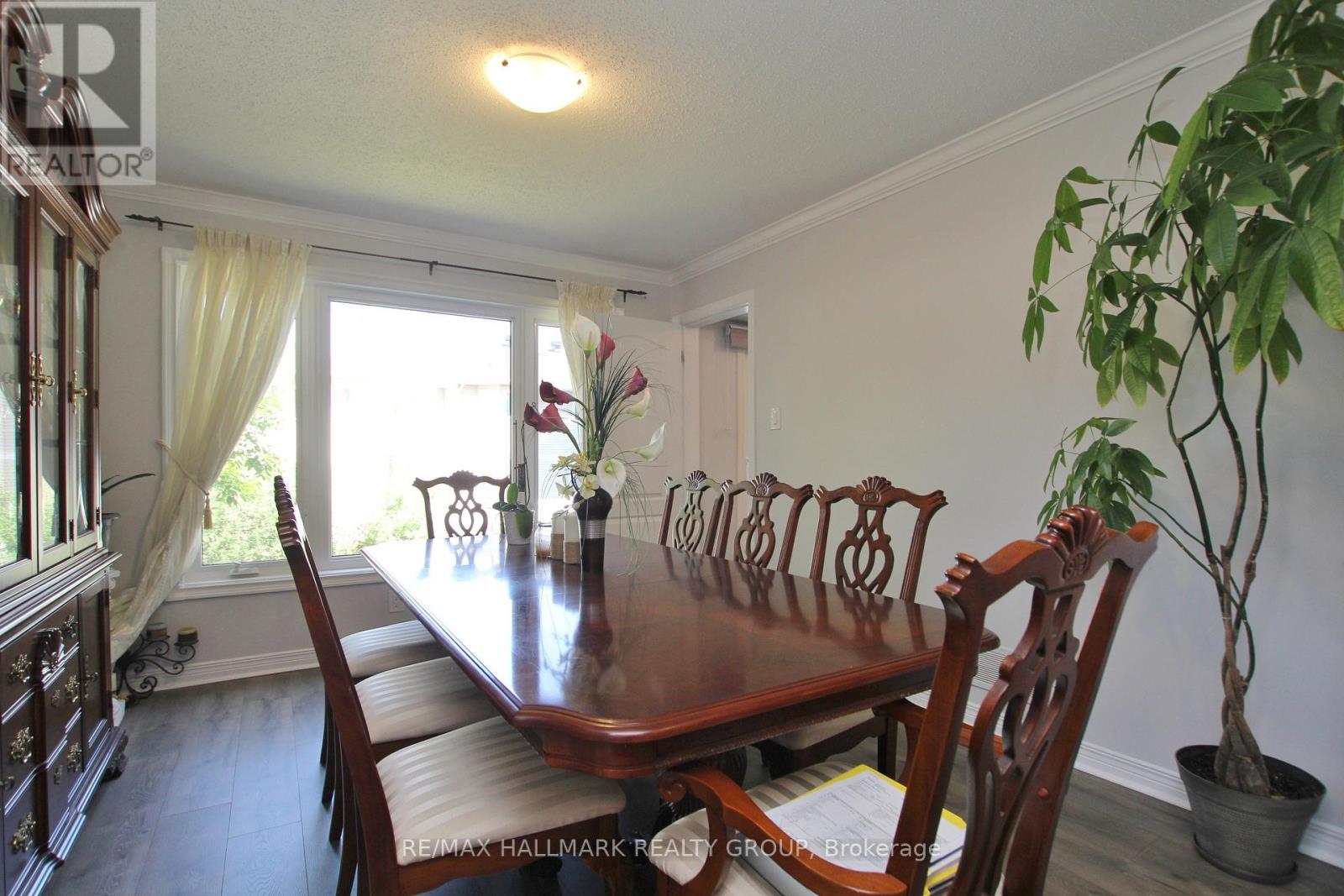 A dining room with a long table and chairs.