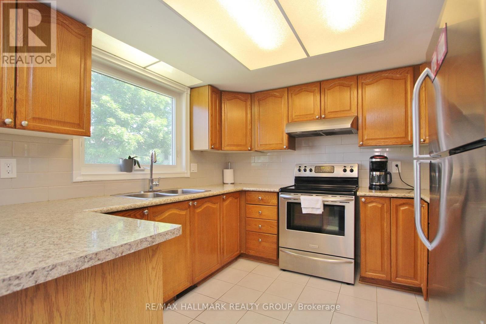 A kitchen with wooden cabinets and stainless steel appliances.