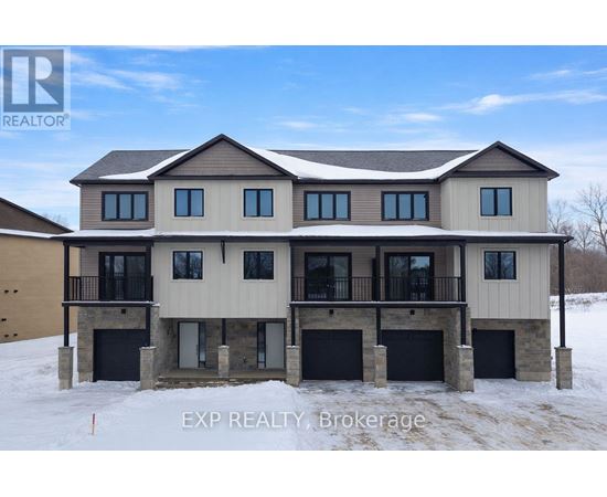 A large, modern house with a balcony and multiple garages is for sale.