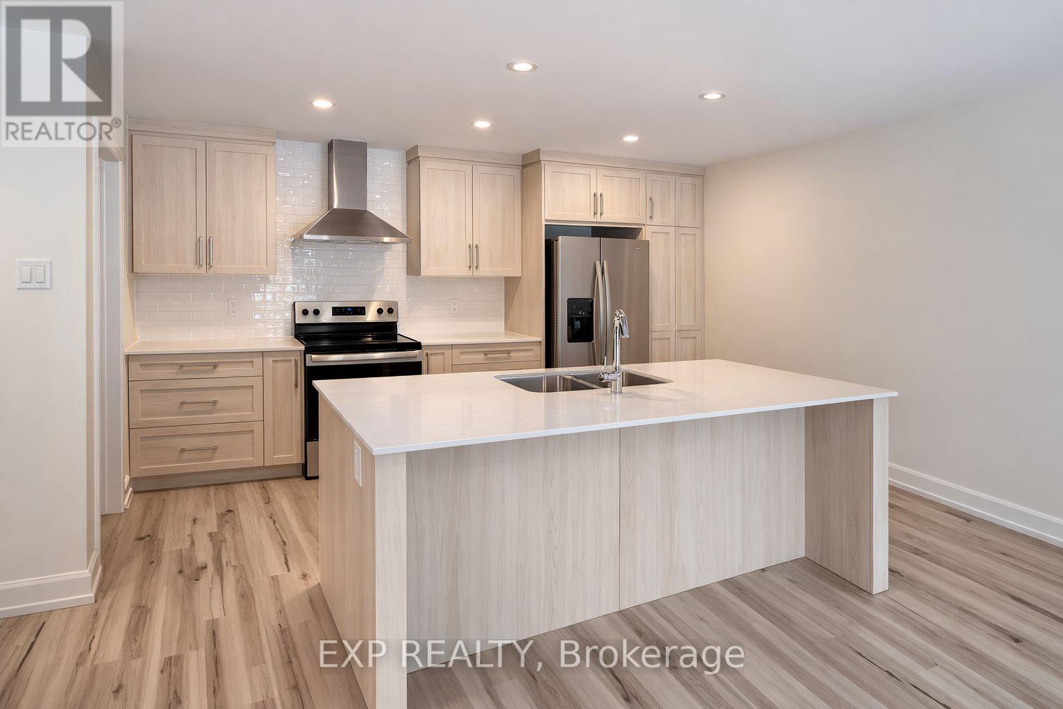 A kitchen with a white countertop and wooden cabinets.