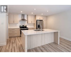 A kitchen with a white countertop and wooden cabinets.