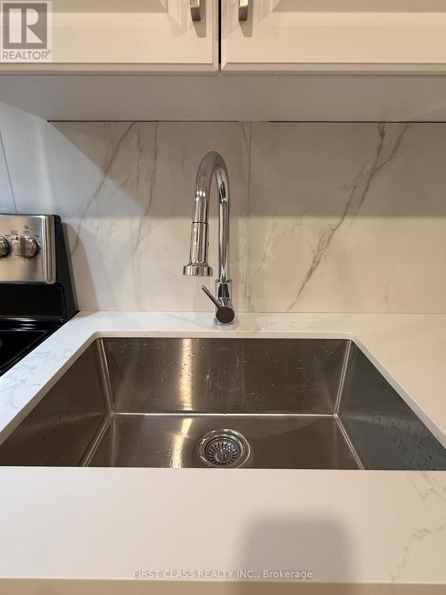 A kitchen sink with a chrome faucet.