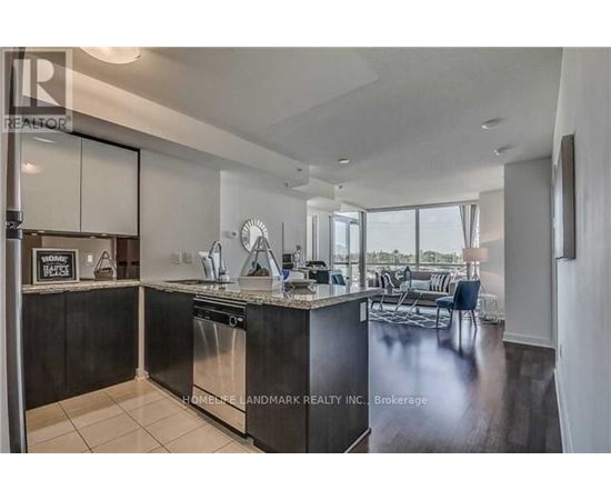 A modern kitchen with a large island and a dining area.