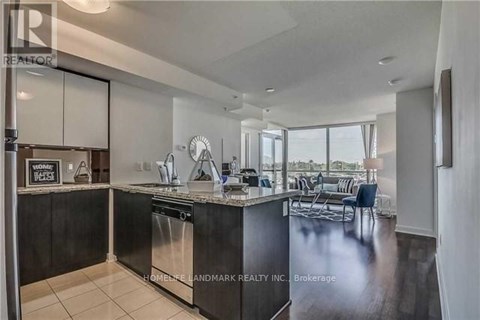 A modern kitchen with a large island and a dining area.