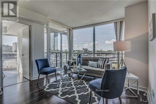 A living room with a view of the cityscape outside the large windows.