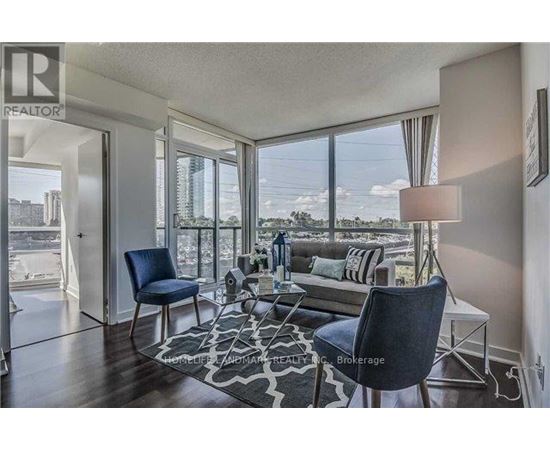 A living room with a view of the cityscape outside the large windows.