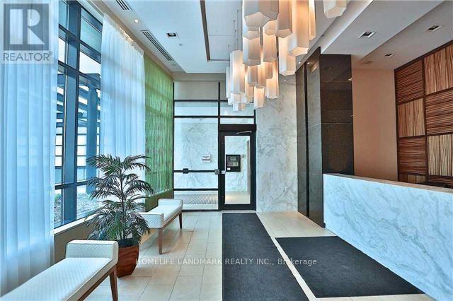 A modern interior space with a reception desk and a potted plant.