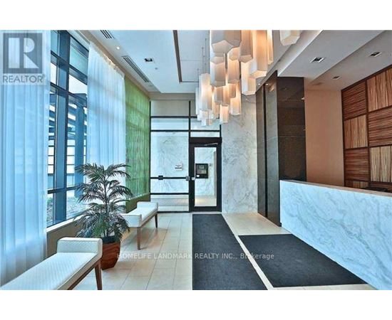 A modern interior space with a reception desk and a potted plant.