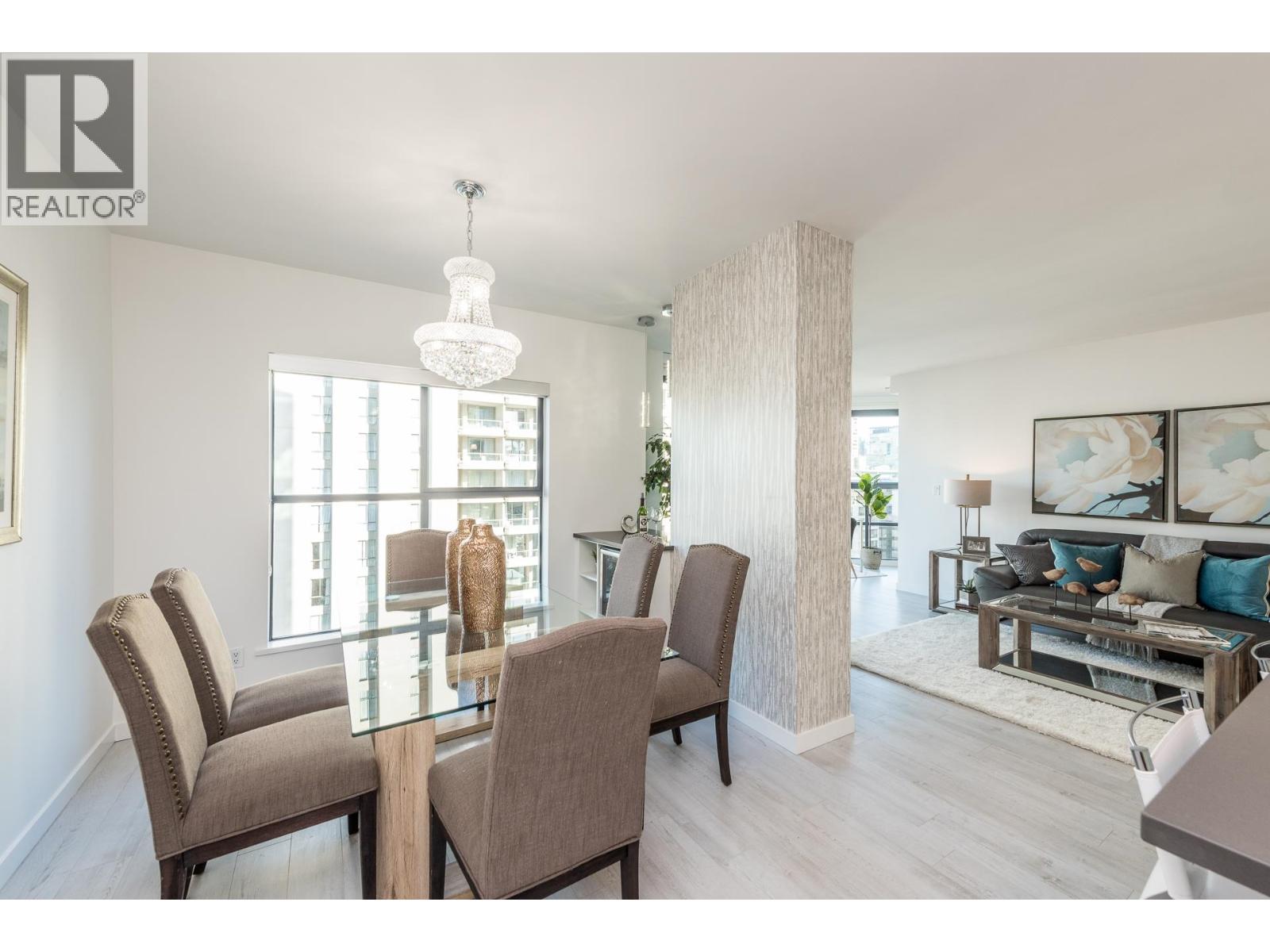A dining room with a glass table and chairs.