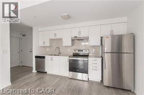 A kitchen with white cabinets and stainless steel appliances.