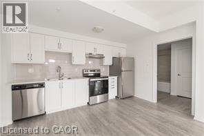 A kitchen with white cabinets and stainless steel appliances.