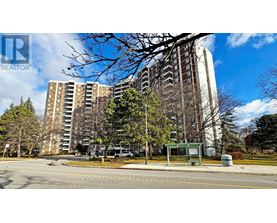 A street view of a residential area with apartment buildings and a sign for Central Home Realty Inc.
