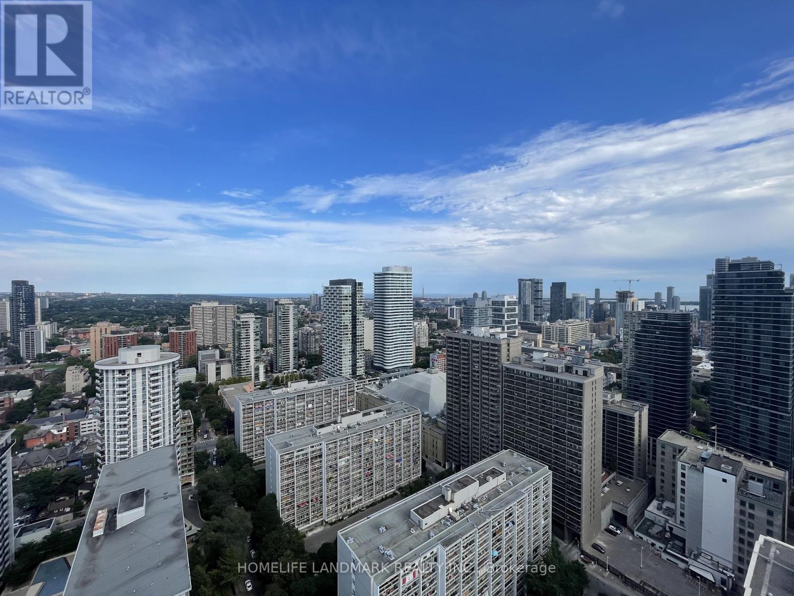 A cityscape with a clear blue sky and buildings of various heights.