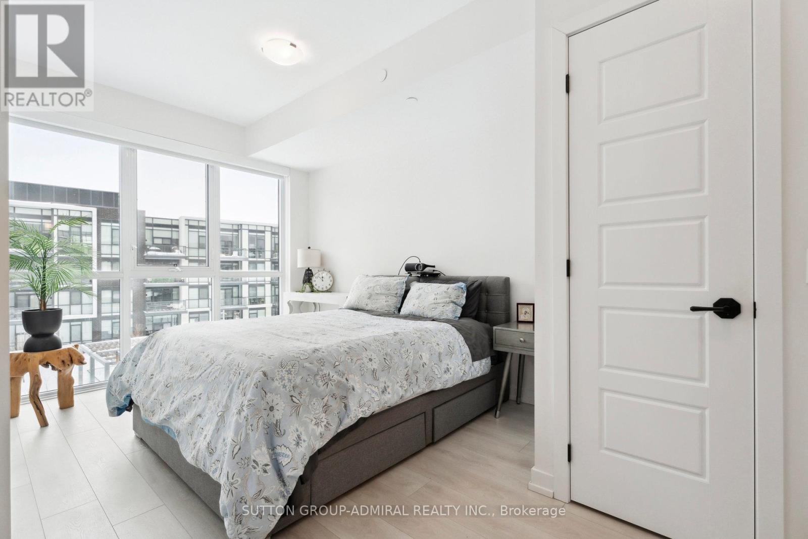 A bedroom with a large bed and a view of the city.