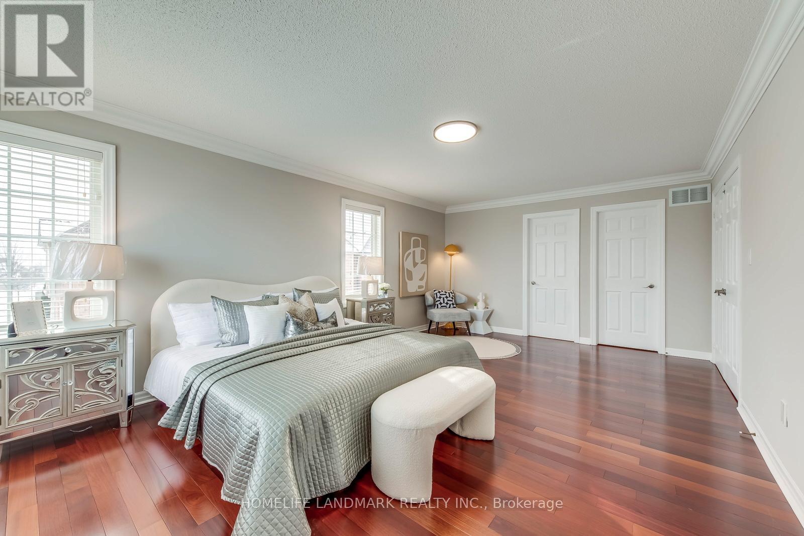 A bedroom with a large bed and a bench.