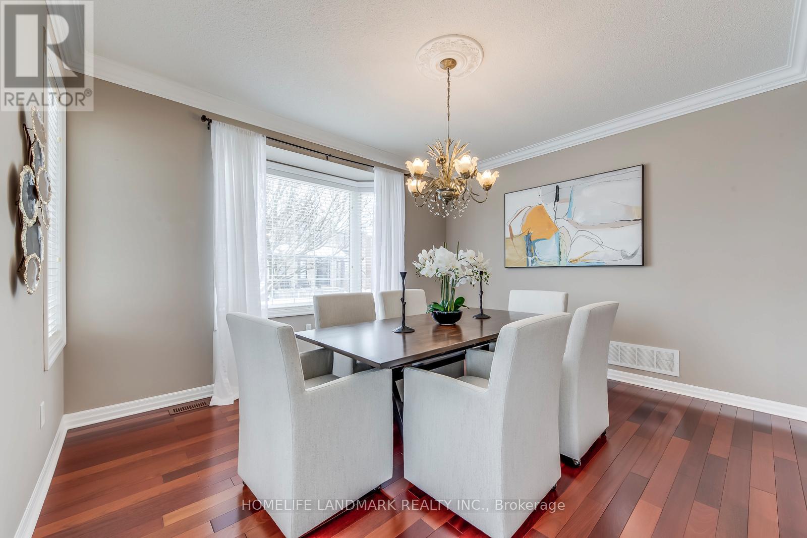A dining room with a table set for four.