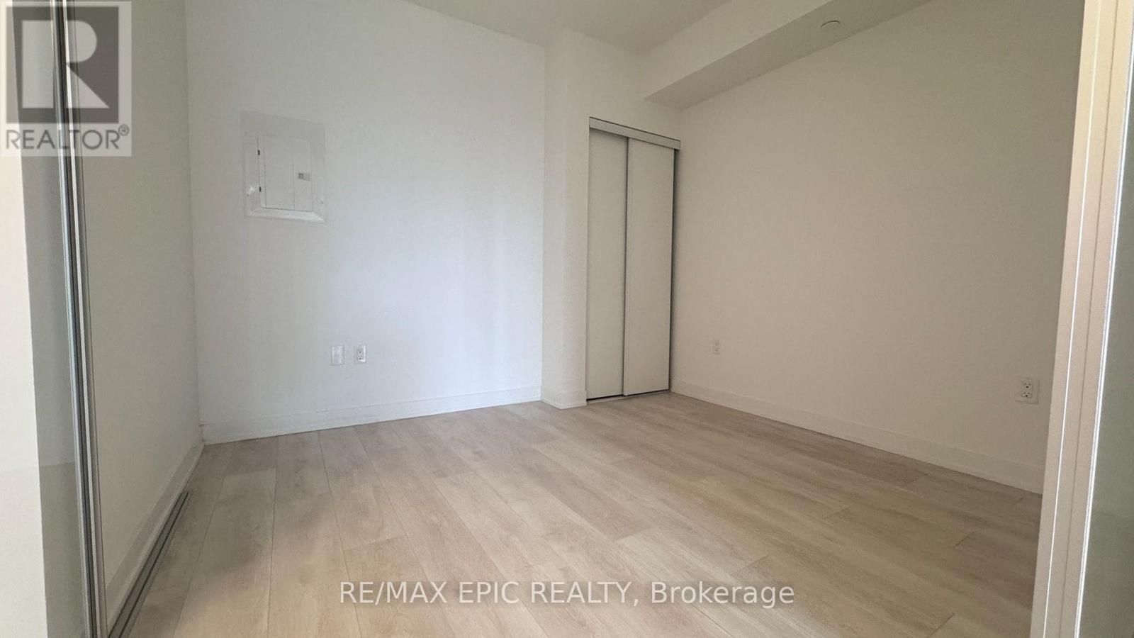 A room with a sliding door and a wooden floor.