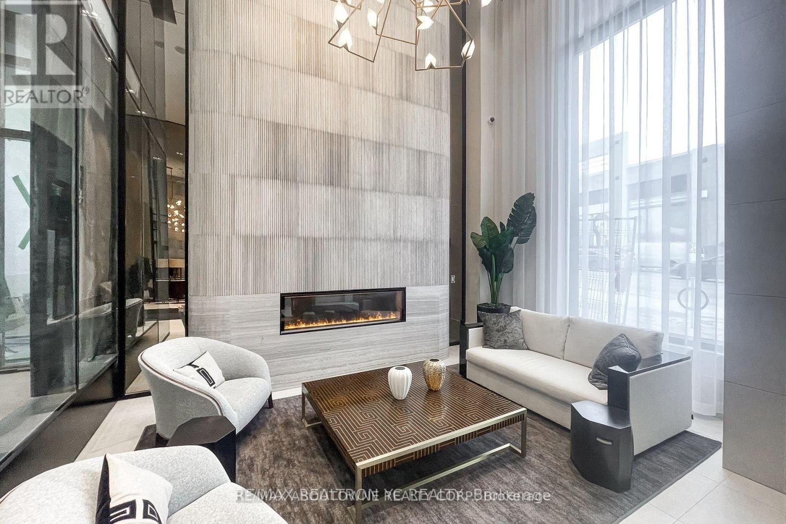 A modern living room with a fireplace and a glass door.