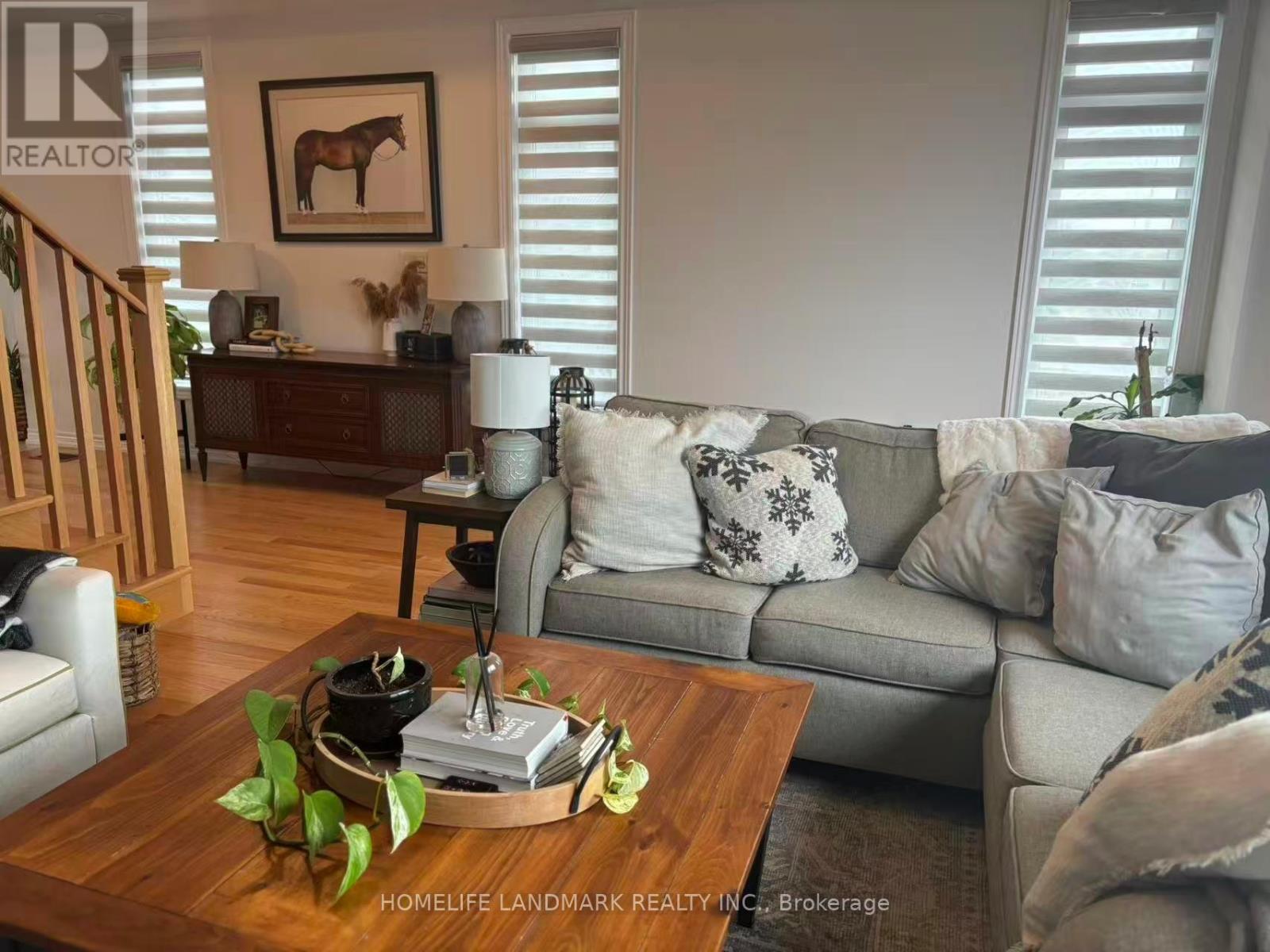A living room with a grey couch and a wooden coffee table.