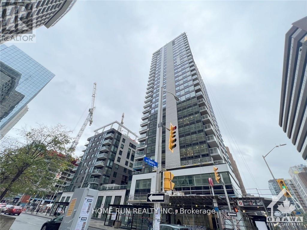 A tall building under construction with a sign that reads "Home Run Realty, INC. Brokerage.".