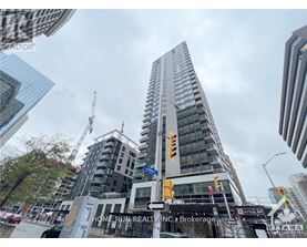 A tall building under construction with a sign that reads "Home Run Realty, INC. Brokerage.".