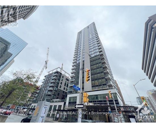 A tall building under construction with a sign that reads "Home Run Realty, INC. Brokerage.".