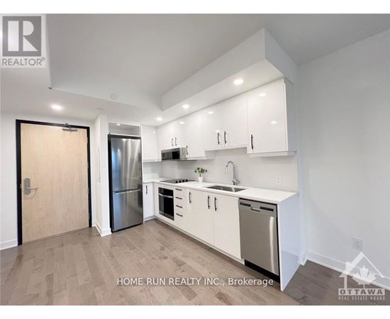 A kitchen with white cabinets and stainless steel appliances.
