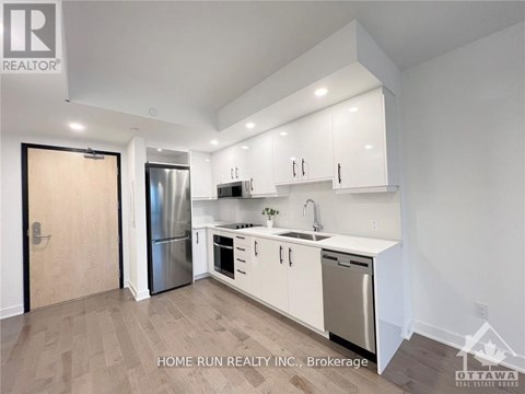 A kitchen with white cabinets and stainless steel appliances.