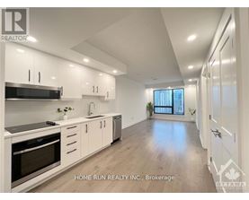 A modern kitchen with white cabinets and stainless steel appliances.