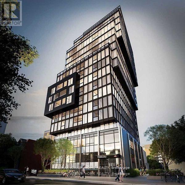 A modern building with a glass facade is depicted in the image.