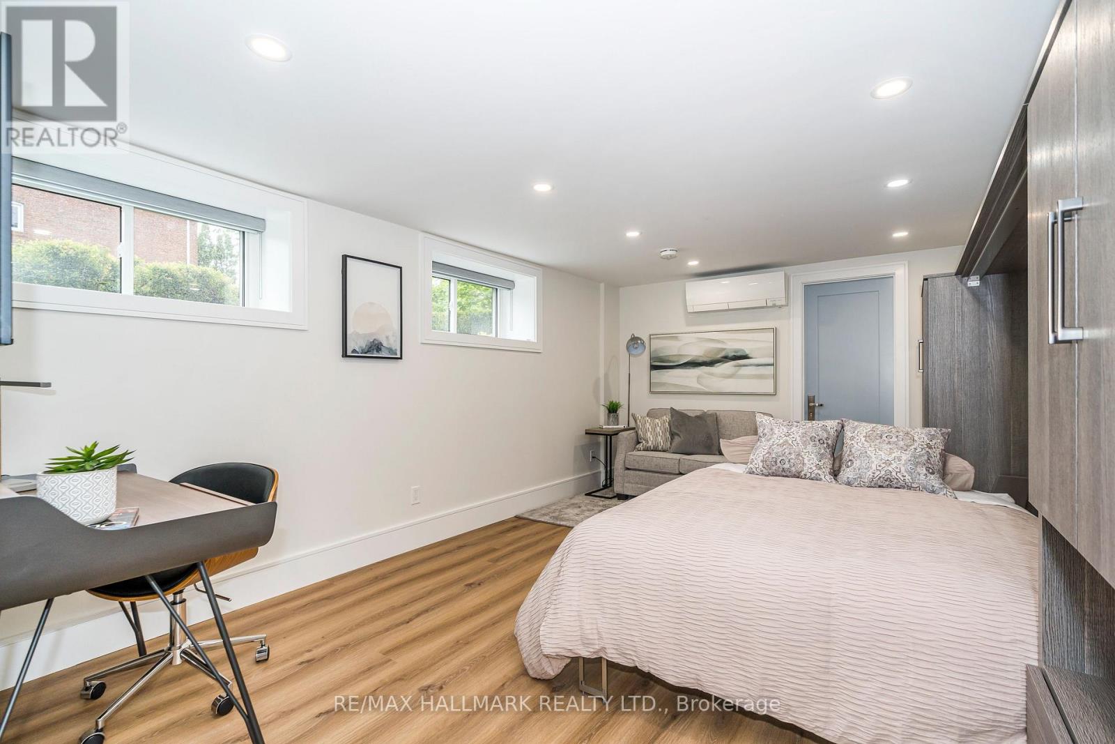 A bedroom with a bed, desk, and chair.