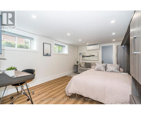 A bedroom with a bed, desk, and chair.