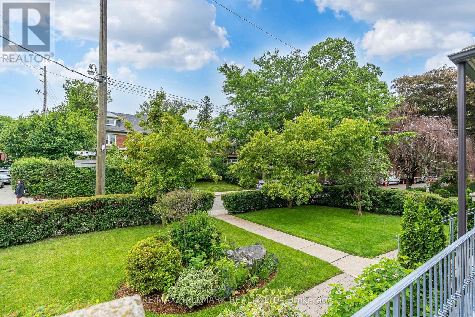 A residential area with a well-maintained lawn and trees.