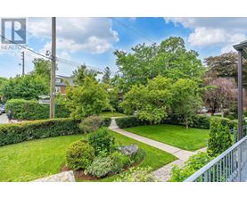 A residential area with a well-maintained lawn and trees.
