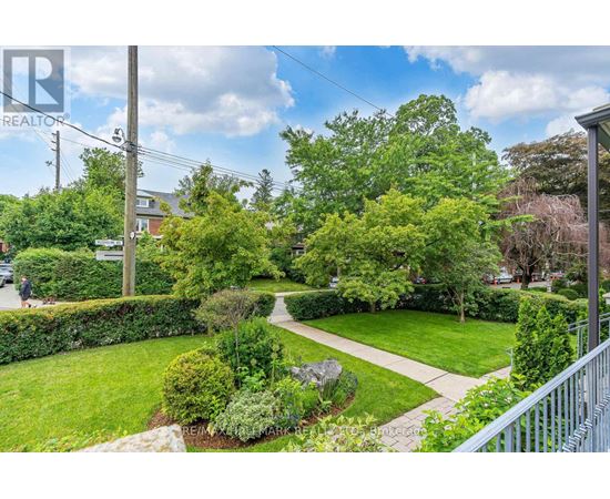 A residential area with a well-maintained lawn and trees.