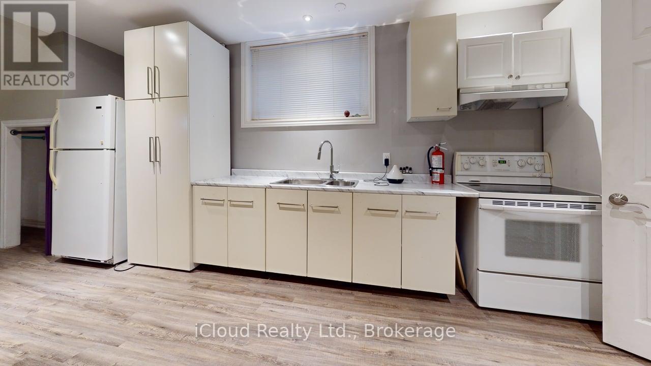A kitchen with white appliances and cabinets.