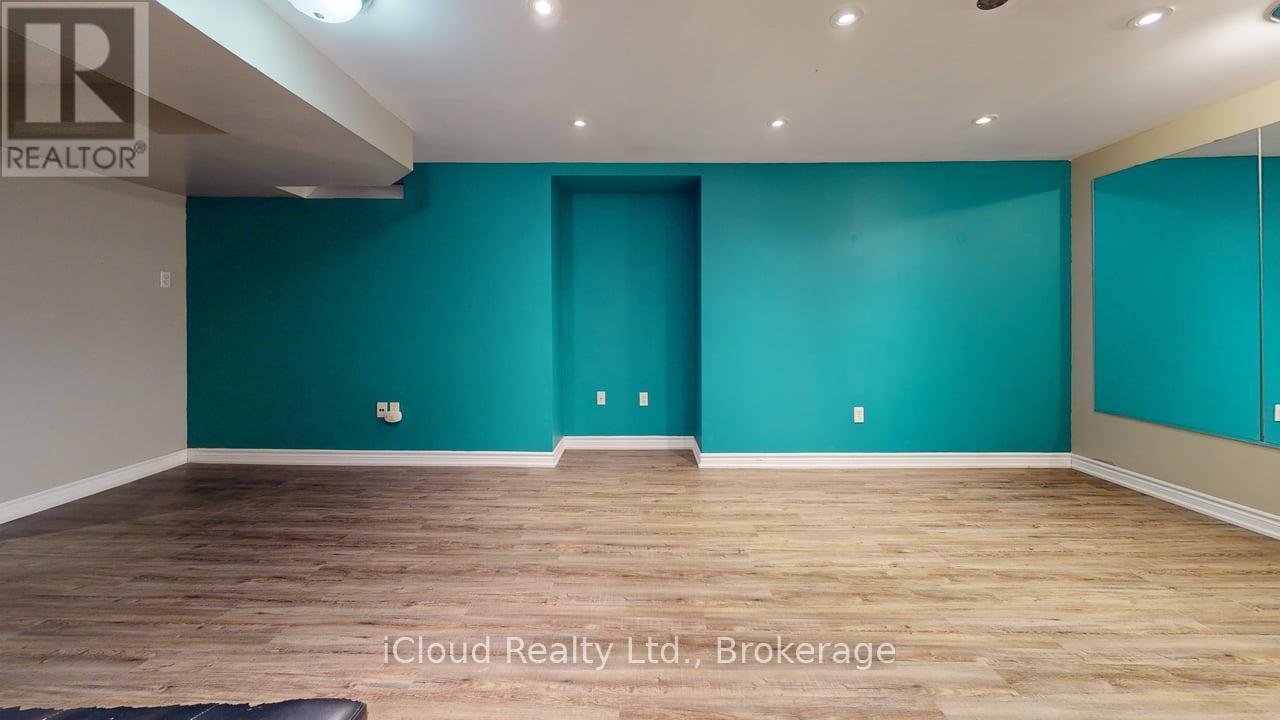 A room with teal walls and wooden flooring.