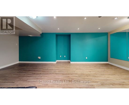 A room with teal walls and wooden flooring.