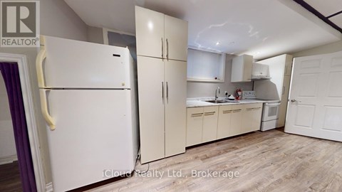 A kitchen with a refrigerator and cabinets.