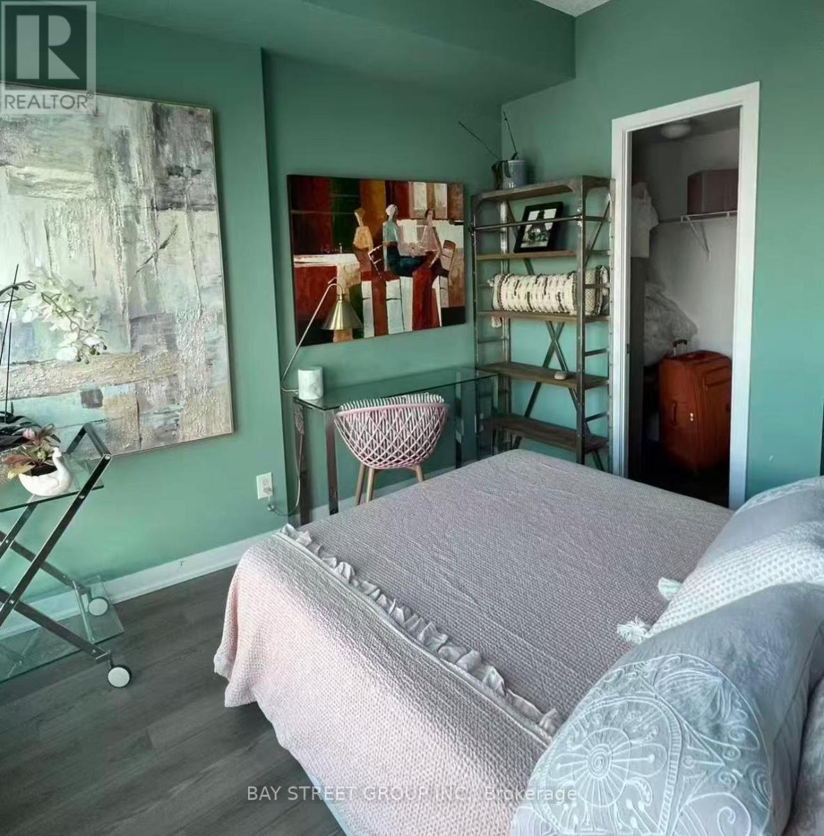 A bedroom with a bed and a chair in it.