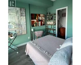 A bedroom with a bed and a chair in it.