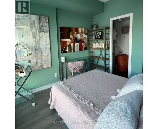 A bedroom with a bed and a chair in it.