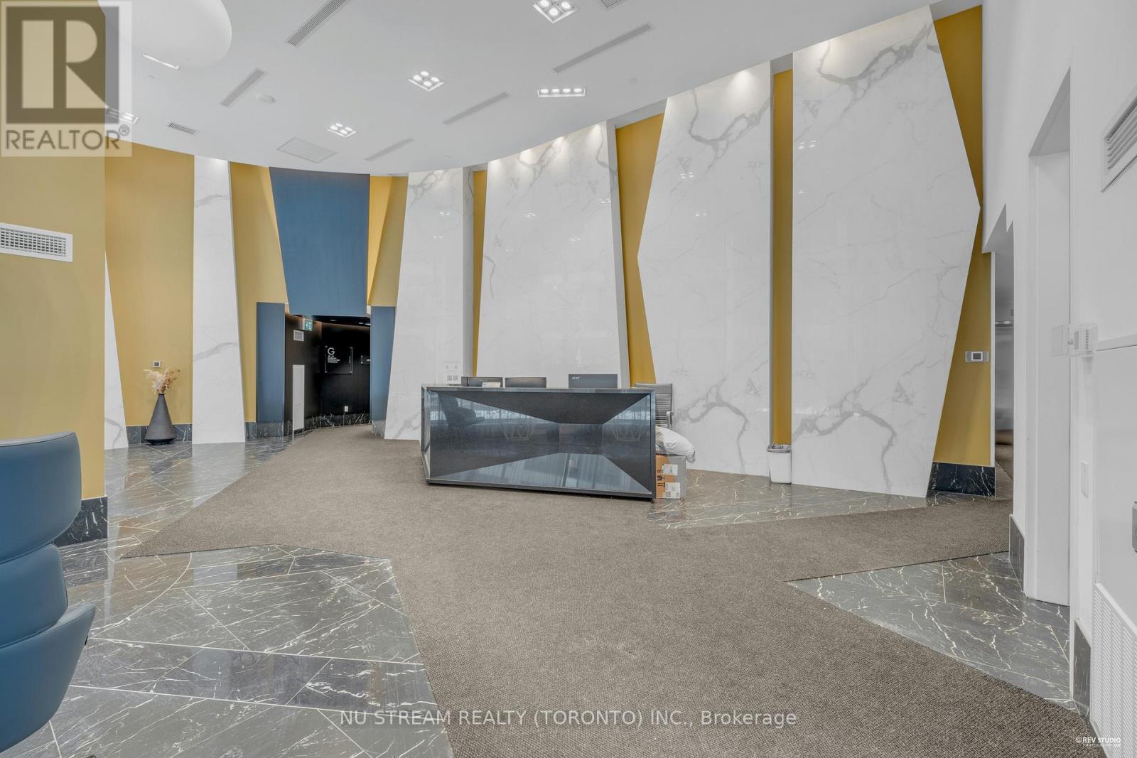 A realtor office with a marble floor and yellow and white walls.